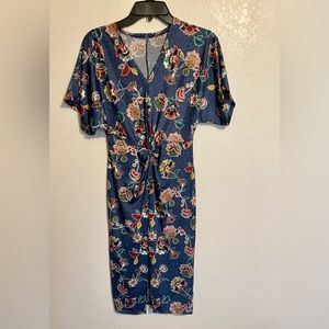 This is a blue dress with beautiful flower design and the fabric stretches.